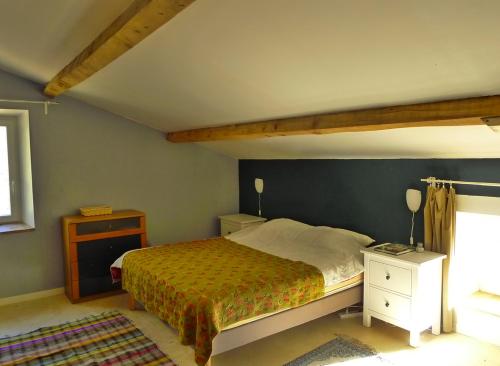 a bedroom with a large bed and a window at Mas de la ferme du pont in Saint-Jean-de-Maruéjols-et-Avéjan