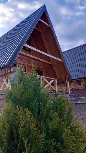 a wooden barn with a blue roof at BRVNARE DJOKIĆ in Ðokici