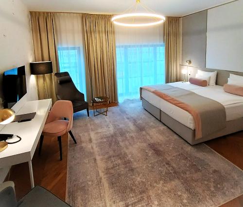 a hotel room with a bed and a desk and a couch at Hotel Ferreus Modern Art Deco in Kraków