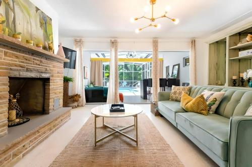a living room with a couch and a fireplace at Fantastic Island House 1 mile to the beach with heated pool in Sarasota