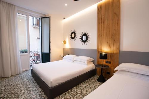 En eller flere senge i et værelse på BADIA NUOVA Apart Hotel