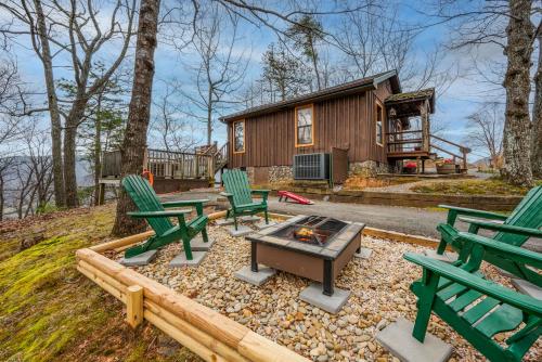 a backyard with green chairs and a fire pit at Authentic, Rustic, Cute & Cozy! in Pigeon Forge