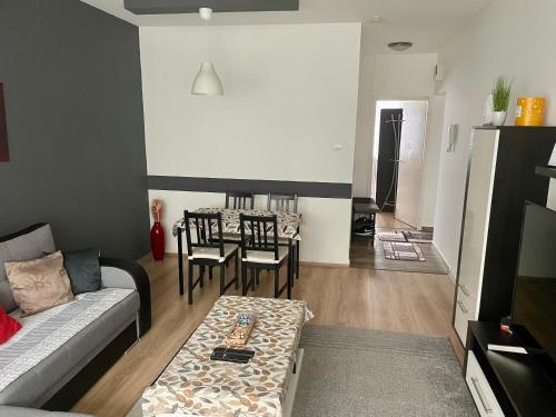 a living room with a couch and a table at City center Zalaegerszeg in Zalaegerszeg