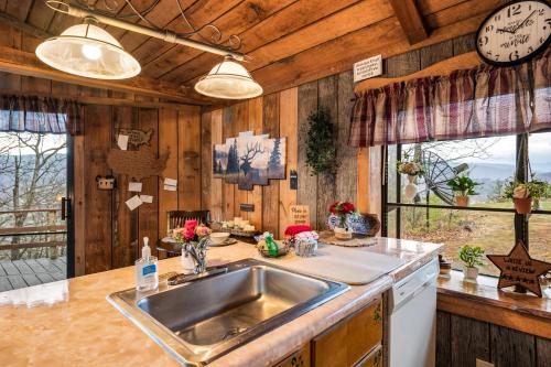 a kitchen with a sink and a counter at Authentic, Rustic, Cute & Cozy! in Pigeon Forge