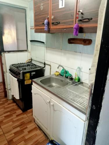 cocina con fregadero y fogones en Habitaciones Pabla en Santiago