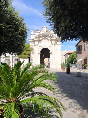 a building with an arch in the middle of a street at Casa Lambertina in Senigallia