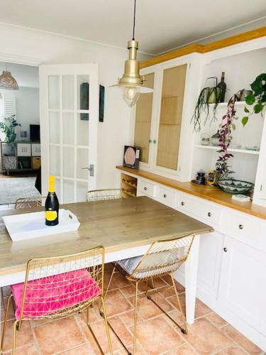 a kitchen with a wooden table and chairs at Charlestown Cottage Harbour & Beach short walk! in Charlestown
