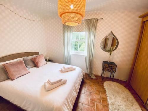 a bedroom with a bed with two towels on it at Charlestown Cottage Harbour & Beach short walk! in Charlestown