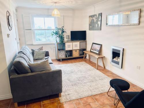 a living room with a couch and a fireplace at Charlestown Cottage Harbour & Beach short walk! in Charlestown