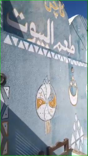 a painting of a bird on a wall with earrings at Taam Al beeyout in Naj‘ al Maḩaţţah