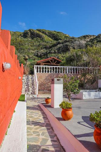 an orange fence with some plants in pots at Angels beach house in Rhodes Town