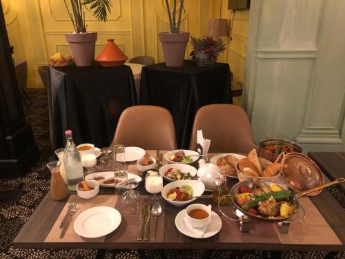 a table with a tray of food on it at Hôtel La Maison Blanche in Tunis