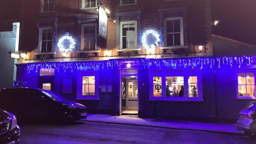 a blue building with christmas lights on it at Bosuns Chair in Lymington