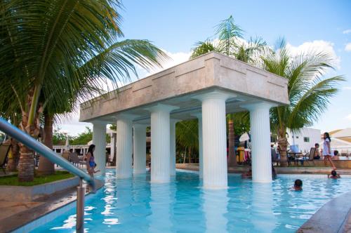 a swimming pool with a gazebo in the water at Lacqua Diroma Loc Caldas in Caldas Novas