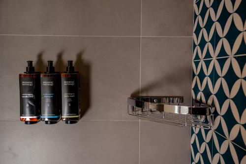 two batteries are sitting on a wall in a bathroom at BADIA NUOVA Apart Hotel in Trapani