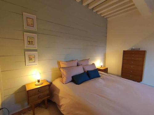 a bedroom with a large bed with two night stands at La maison du Boulanger in Pontaubert
