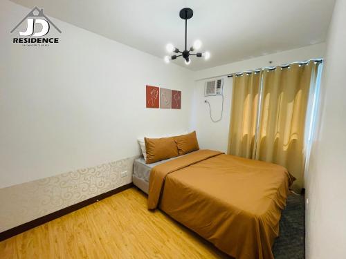 a bedroom with a bed and a couch in it at JD Residence - 1 Bedroom Unit in Davao City