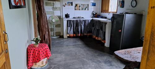 eine Küche mit einem Kühlschrank und einem Tisch im Zimmer in der Unterkunft Cabaña Murringo in Necoclí
