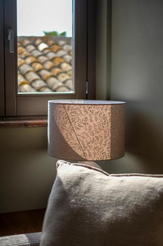a lamp sitting on a table next to a window at Masseria del Carboj in Menfi