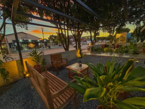 a patio with chairs and a table and some plants at Pousada de Bonito in Bonito