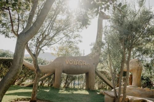 a statue of an elephant in a park with trees at Voyacasu in Villa de Leyva