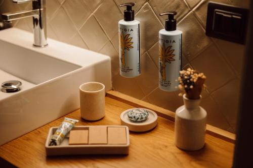 a bathroom with three bottles and a sink at Masseria del Carboj in Menfi