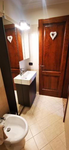a bathroom with a toilet and a sink and a door at Dimora Charme in Monterotondo