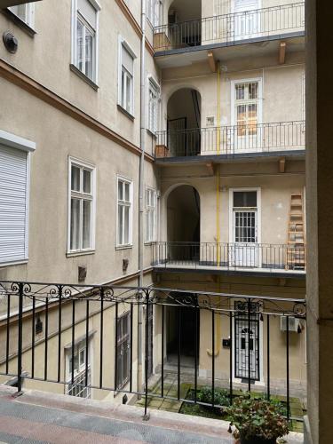 an apartment building with balconies on the side of it at Dembinszky utca in Budapest