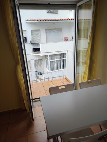 a table and chairs with a view of a balcony at Racing Mackerel Hostel in Lagos