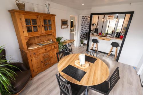 a kitchen and dining room with a wooden table and chairs at Charmant appartement Vosgien centre Saint Dié, proche montagnes in Saint Die