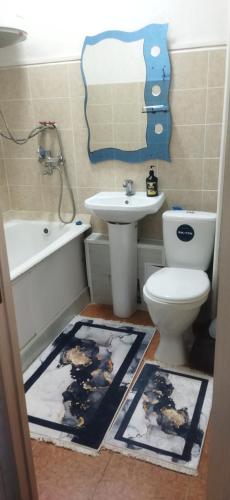 a bathroom with a toilet and a sink at Квартира in Taraz