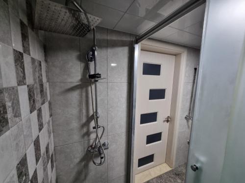 a bathroom with a shower and a door at Sea view lux in Baku