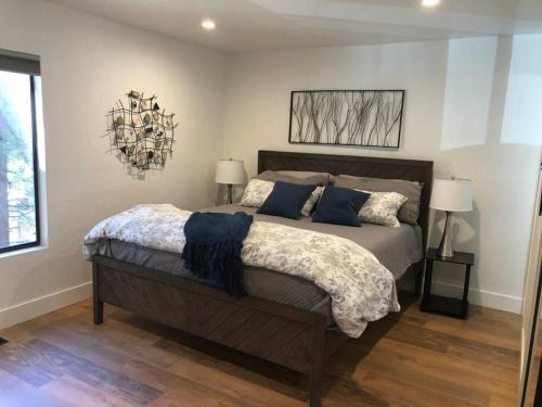 a bedroom with a large bed with blue pillows at Fun & Air Conditioned Lake Tahoe 3 BR/2.5 BA Home in Incline Village