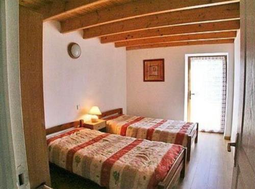 une chambre avec deux lits et une fenêtre dans l'établissement Charmante petite maison bretonne, à Rosporden