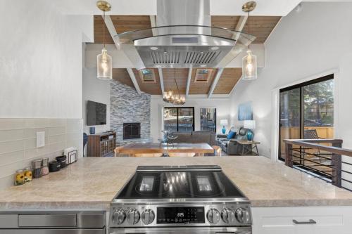 a kitchen with a stove and a living room at Fun & Air Conditioned Lake Tahoe 3 BR/2.5 BA Home in Incline Village