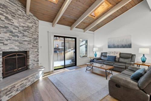 a living room with a couch and a fireplace at Fun & Air Conditioned Lake Tahoe 3 BR/2.5 BA Home in Incline Village