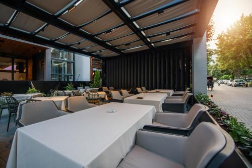 a row of tables and chairs in a restaurant at Seraphine Plaza in Peje