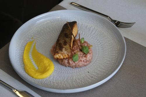 a plate of food with a sandwich and a banana at Seraphine Plaza in Peje