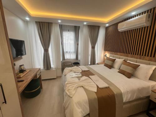 a hotel room with a large bed and a desk at Ninova Boutique Hotel in Istanbul