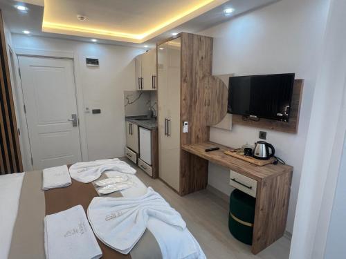 a small room with a kitchen and a television at Ninova Boutique Hotel in Istanbul