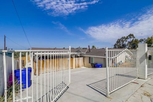 a white fence in front of a house at Entire First-Floor 3-Bedroom w Gated Yard, Laundry, Crib, Fast Wi-Fi, Private Rental, No Deposit in San Diego
