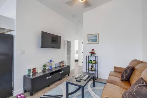 a living room with a couch and a tv at Entire First-Floor 3-Bedroom w Gated Yard, Laundry, Crib, Fast Wi-Fi, Private Rental, No Deposit in San Diego