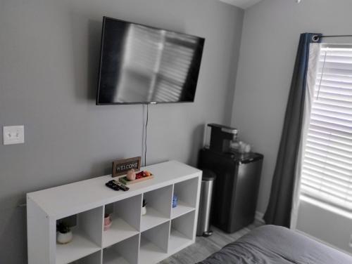 ein Schlafzimmer mit einem weißen Tisch und einem TV an der Wand in der Unterkunft la casa de Carmen in Charlotte