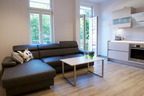 a living room with a couch and a table at Altstadt Appartements Goslar in Goslar