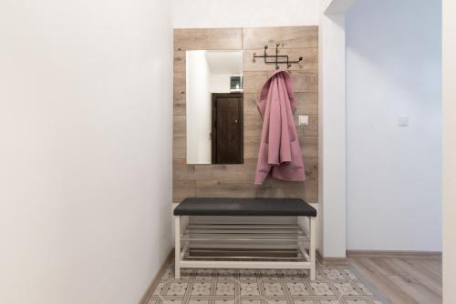 a bathroom with a bench and a mirror at Apartment KALINA with free private parking in Plovdiv