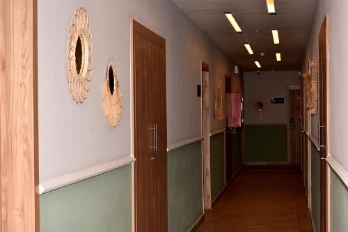 a hallway of a hospital with doors and a hallwayngth at L'escale Hôtel & Spa By 7AV HOTELS in Ouazzane