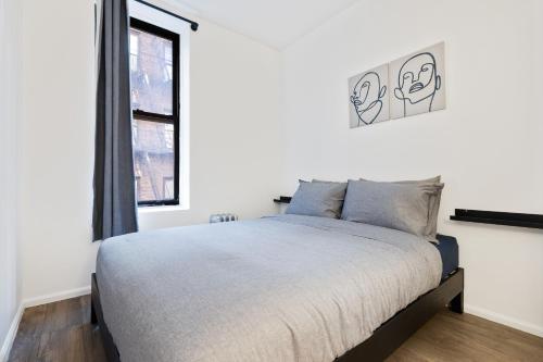 a bedroom with a bed and a window at Inspiring Urban Life, Times square Apartments in New York