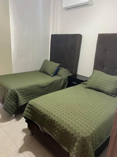 Ένα ή περισσότερα κρεβάτια σε δωμάτιο στο Departamento frente al estadio TSM