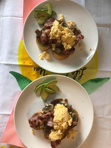 two plates of food on a table at Rimu View 1 by Tiny Away in Hokitika