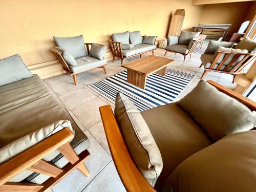 a living room with couches and chairs and a table at Vue exceptionnelle sur la baie de Collioure in Collioure